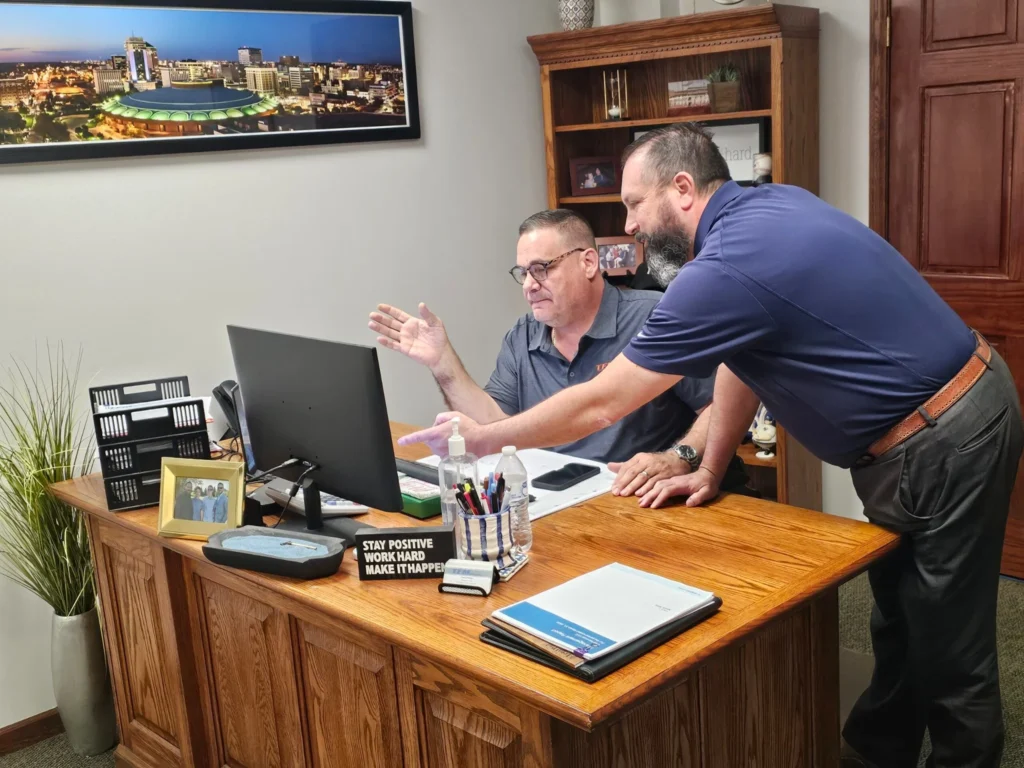 TFM Services leadership team collaborating in an office